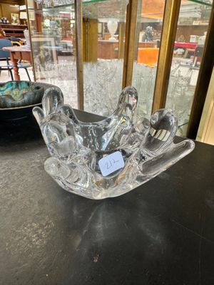 glass bowl on a table in front of a glass display case