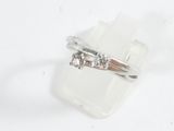 a ring with three diamonds on it sitting on a piece of plastic