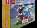 a box with a lego creator set in it on a black background