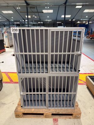 a metal cage that is sitting on a pallet in a warehouse
