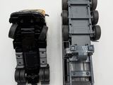 two toy cars that are sitting side by side on a white surface