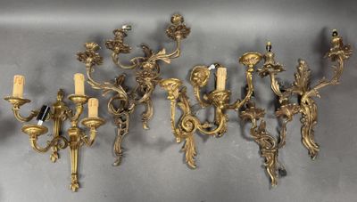 six antique brass wall sconces with candles and a candle holder