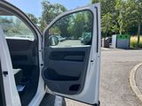 the open door of a white van parked in a parking lot