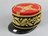 a red and black hat with gold decorations on it