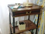 a small table with books on it in front of a window