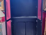 a black cabinet with a mirror on it in a room