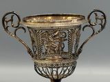 silver plated cup on stand on grey background with silver background