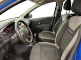 the interior of a blue car with a steering wheel and dashboard
