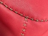a close up of the stitching on the inside of a red purse