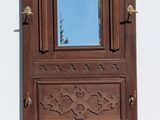 a wooden door with a mirror on the side of it
