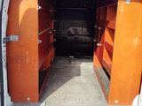 a white van with orange doors open in a parking lot