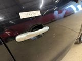 a close up of a car door handle with a sticker on it
