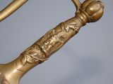 a close up of a gold sword with a handle