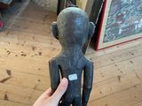a person that is holding a statue in their hand