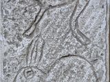an image of a stone plaque with a drawing of a man riding a horse