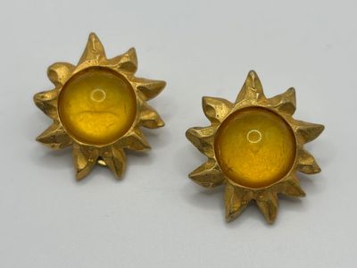 pair of yellow glass sunbursts on a white surface