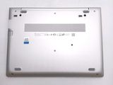 a close up of a silver laptop with a blue sticker on it