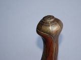 a close up of a cane handle on a white surface