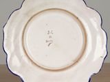 a white plate with a blue rim on a wooden table