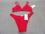 a close up of a red bikini with a tag on it