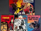 six comic books on a gray surface with a man on a horse