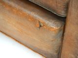 a brown piece of luggage sitting on top of a white table