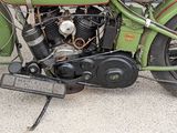 a green motorcycle parked on the side of the road