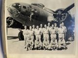 black and white photograph of a group of men in front of an airplane