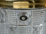 a glass vase with a gold lid on a table