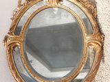 a mirror hanging on the wall next to a wall