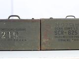 these are two old army tins that are sitting on a table