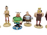 five figurines of different characters on a white background