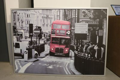 a picture of a red double decker bus going down the street