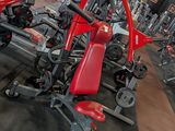 rows of red and black gym equipment in a gym room
