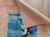 a close up of a rug with a piece of fabric on it