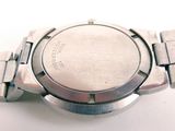 a close up of a watch on a white surface
