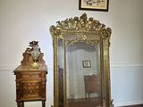 a mirror sitting on the floor next to a dresser
