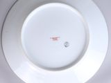 a white plate with a red and white design on it