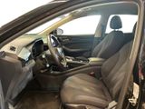 the interior of a car with the door open and the driver ' s seat down