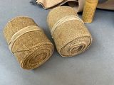 two rolls of burlock on the ground next to a roll of burlock