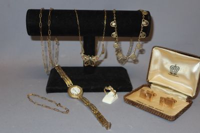 several pieces of jewelry are displayed in a display case