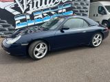 an image of a blue sports car parked in front of a building