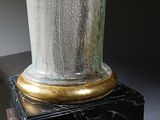 a vase that is sitting on top of a wooden stand