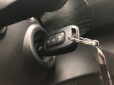 a close up of a car ' s key in the center of the steering wheel