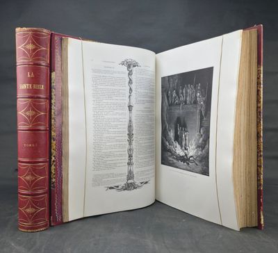 an open book sitting on top of a table next to a black and white photo