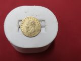 an image of a gold coin sitting on top of a white box
