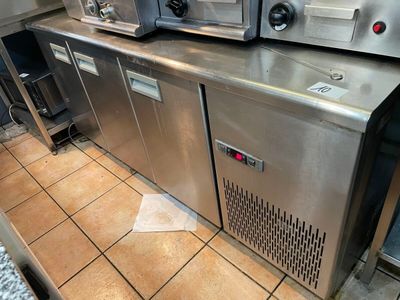 stainless steel counter top in a commercial kitchen with ovens on it