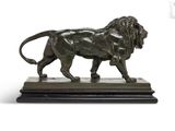bronze statue of a lion on a marble base