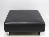 black leather ottoman with chrome legs on a white background