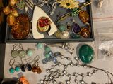 a box full of assorted jewelry on a table